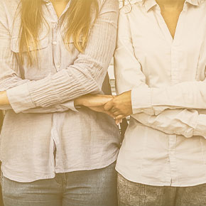 Picture of two women crossing their arms and holding hands like that.